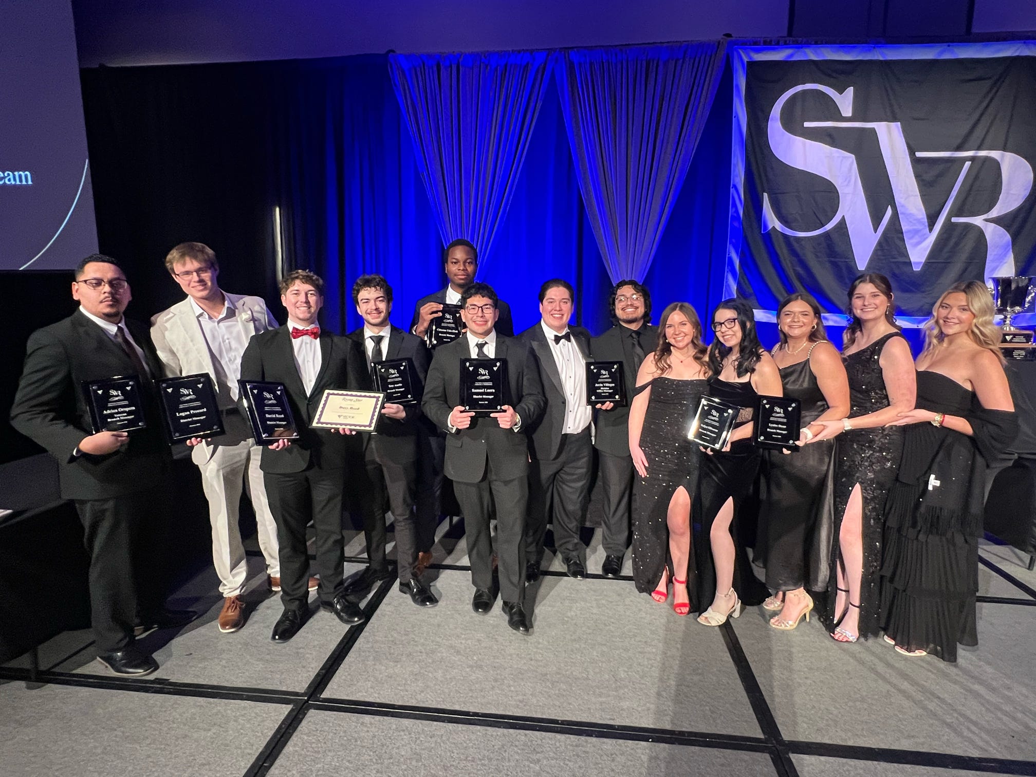 Team receiving awards on stage