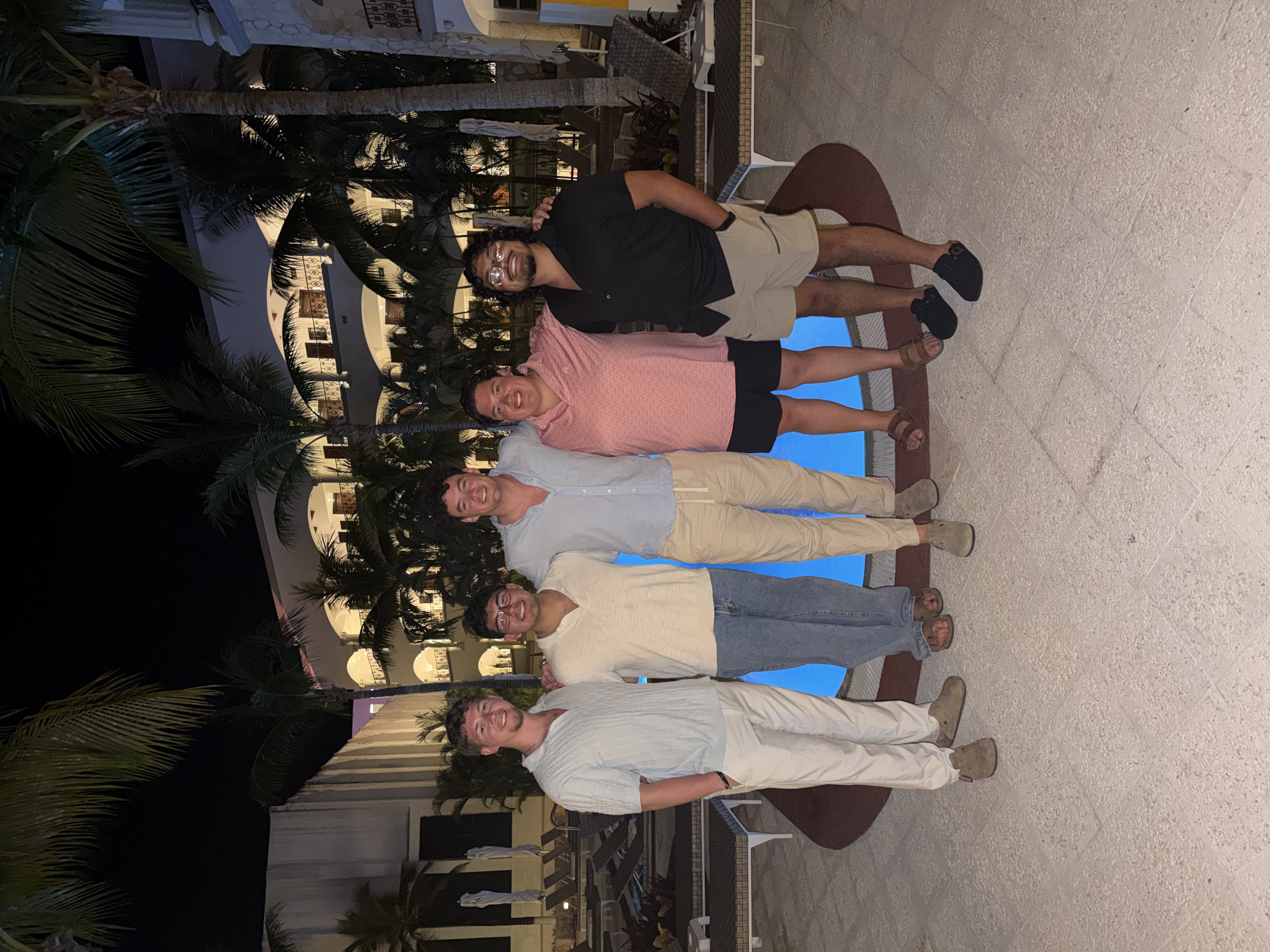 Team at resort pool at night